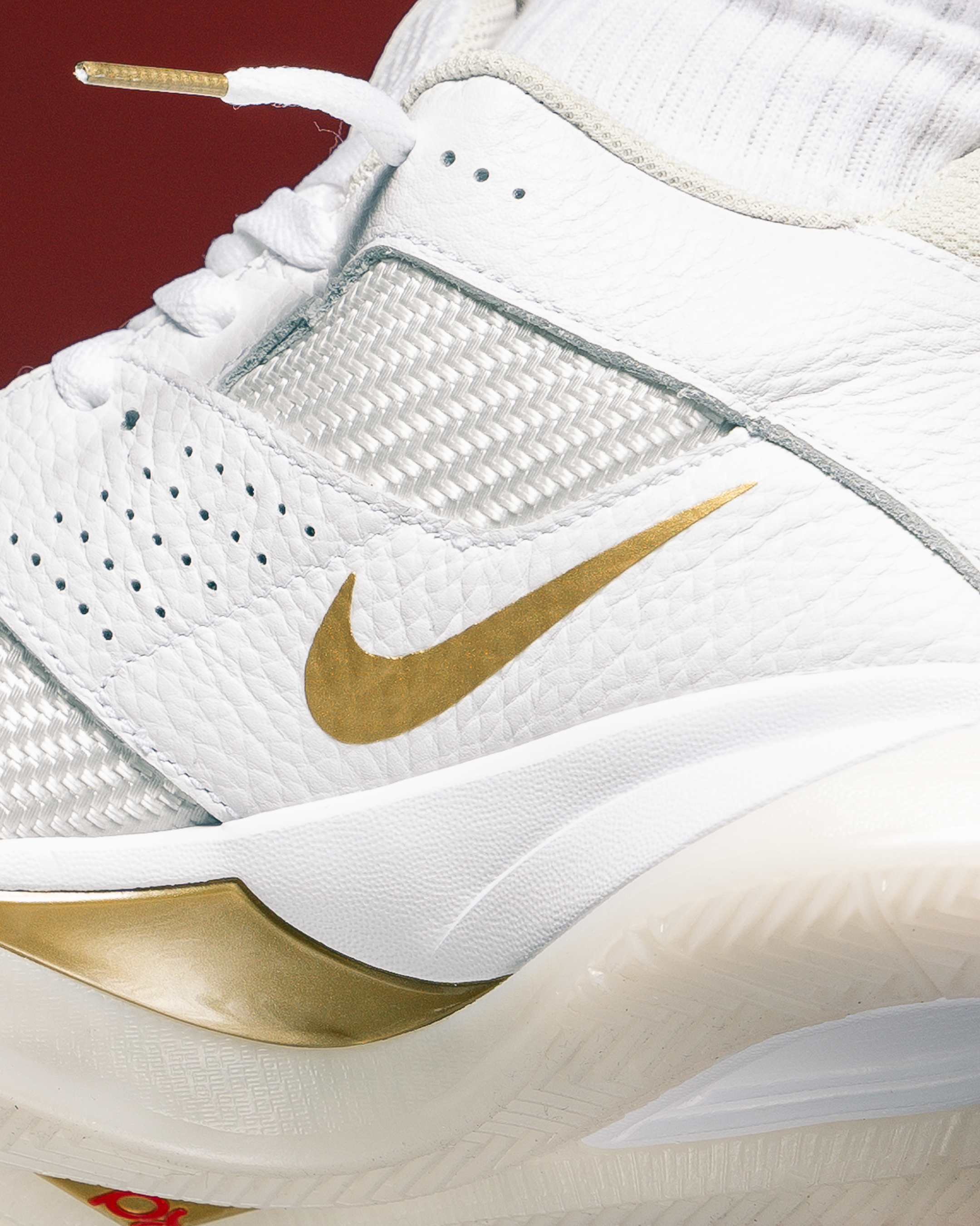 white nike basketball shoes with gold swoosh